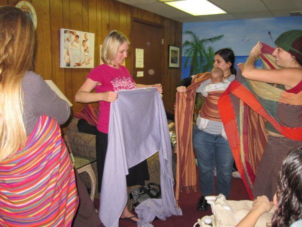 Learning to use woven wraps at a babywearing group meeting.